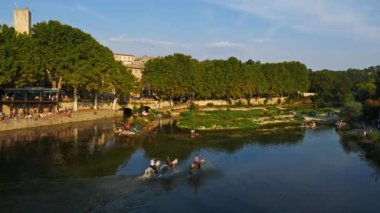 Sommieres, Gard, Occitanie, Fransa. Beyaz Camargue atları Vidourle nehrinde koşuyor.
