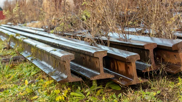 old abandoned rusty rails in the grass