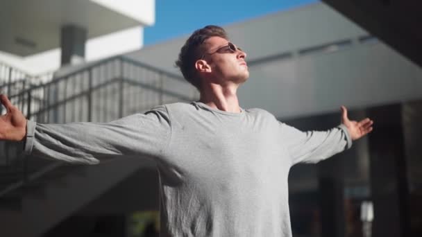 Handsome Stylish White Man Sunglasses Raises His Hands Sides Background — Stock Video