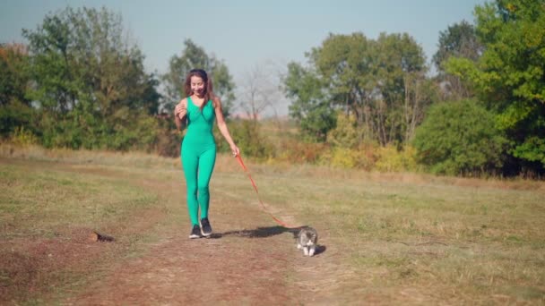 Beautiful Athletic Woman Sporty Turquoise Overalls Walks Her Fluffy Cat — Stock Video