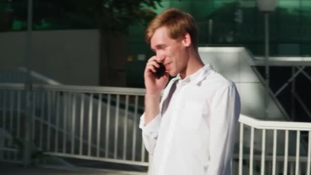 Handsome Young Man White Shirt Walking Using Mobile Phone Finds — Stock Video