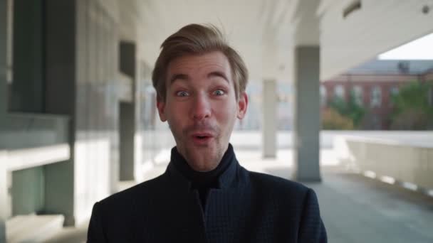 Portrait Happy european man dancing with folder of documents in hand in urban background, showing yeah gesture victory, he achieved result, goals. Amazed Handsome guy shocked, saying Wow. Slow motion — Stock Video