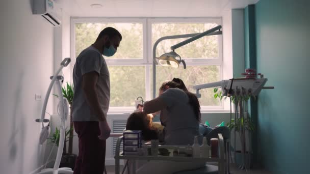 Two Doctors Man Woman Protective Masks Dental Clinic Serve Patient — Stock Video