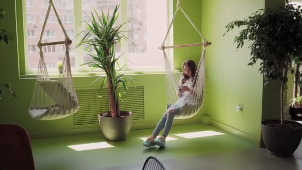 Lonely Beautiful Young Woman Sits Hanging Chair Use Mobile Phone — 비디오