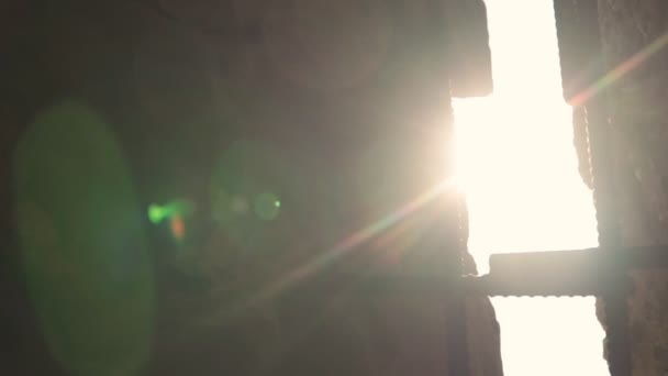 Behind the bars of a prison window the sun shines brightly. Slow motion. Close-up. — Stock Video