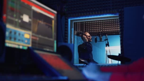 Male Rap Singer with Headphones and Sound Engineer are recording a new song — Stock Video