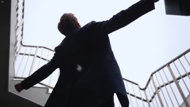 Successful Businessman with Raised Hands Celebrating His Victory During Snowfall — Stock Video