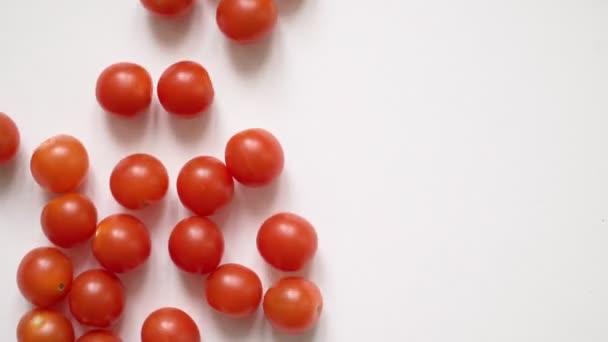 Tomates de pimentão suculentos vermelhos em um fundo branco estendem-se. Espaço vazio para texto — Vídeo de Stock