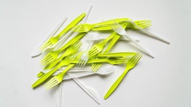 Birçok plastik çatal ve çatal bıçak beyaz arkaplanda metin için bir çerçeve oluşturur.