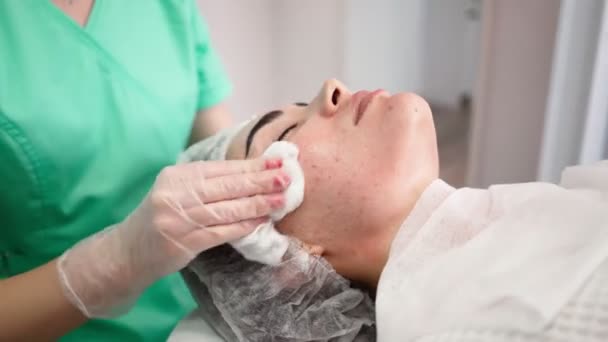 Mujer esteticista hace procedimientos faciales limpia paciente. Spa cuidado de la piel y el cuerpo — Vídeo de stock