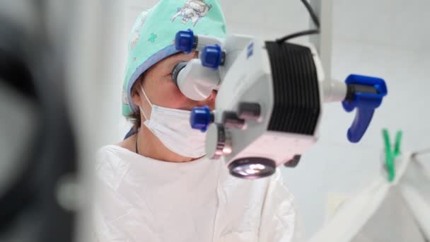用显微镜和医疗仪器进行眼科手术的两名女外科医生 — 图库视频影像