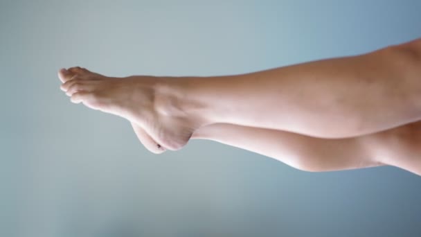 Gyönyörű jól ápolt női láb tiszta bőr elegánsan mozog szürke háttér — Stock videók