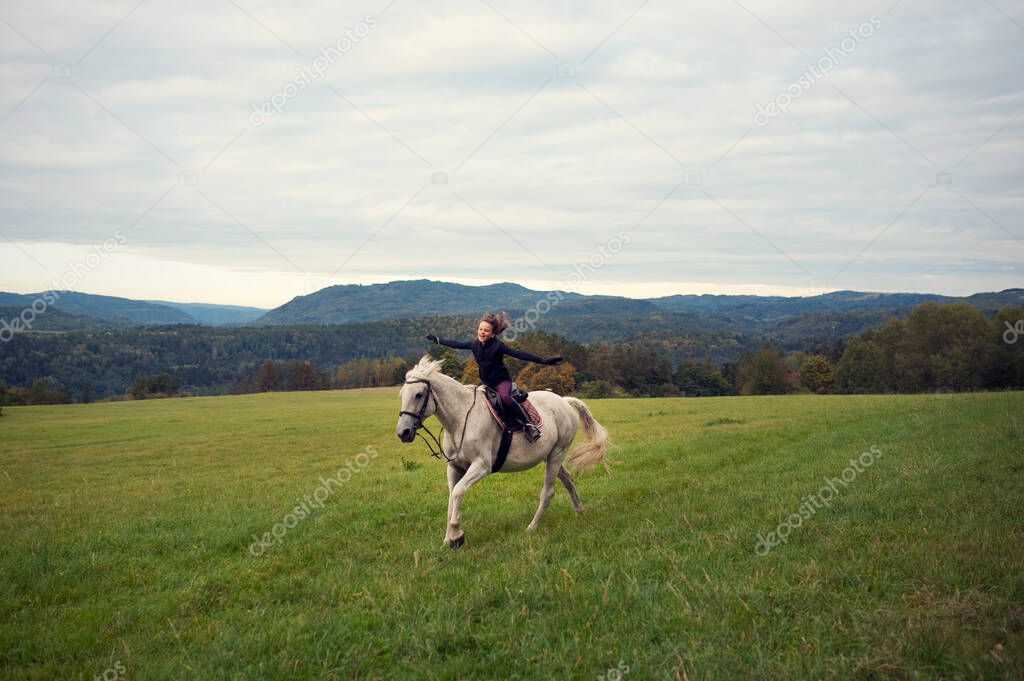 Girl with horse. The girl horseback riding in bautiful landscape. Girl in the saddle on horse