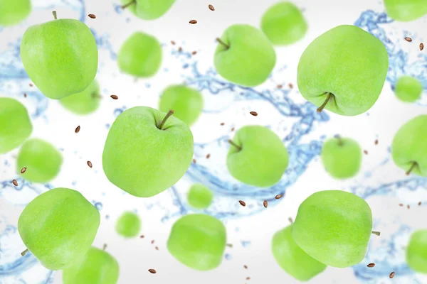Fresh green apples with seeds in water splash over white background. Flying green apples, in the air. Green apples in water