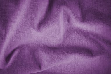 Texture of crumpled purple cotton fabric. Purple background for text and design. Texture of violet crumpled italian fabric