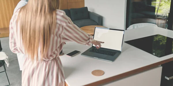 Cropped back view of family couple of business on the kitchen with laptop mockup