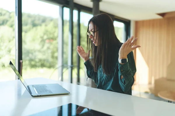 Side view of successful business woman working from home with laptop