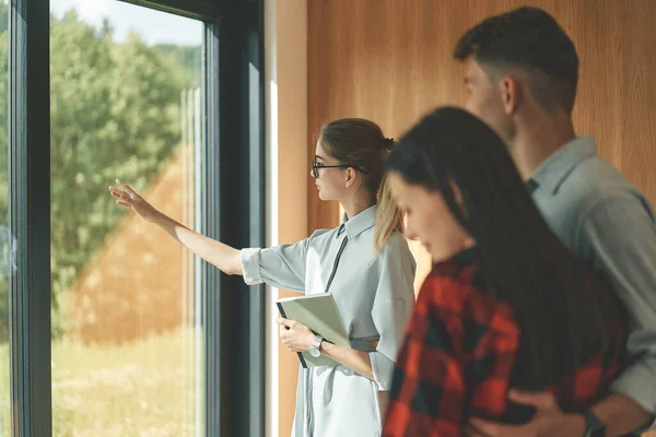 Successful real estate agent woman making presentation of house