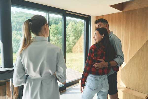 Back view of family couple meeting with landscape designer 