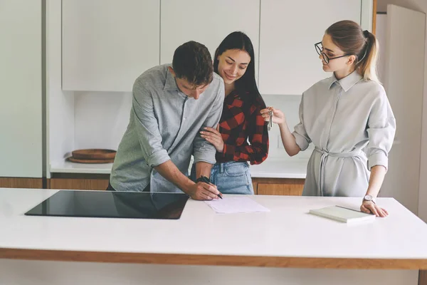 Successful family couple signing the lease agreement