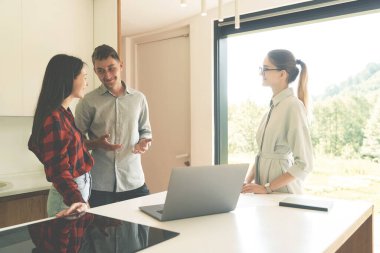 Side view of successful realtor woman talking with clients 