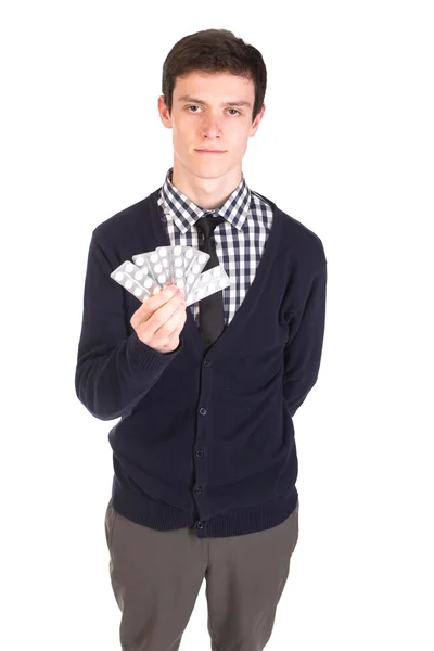 Hombre guapo sosteniendo un paquete de pastillas —  Fotos de Stock