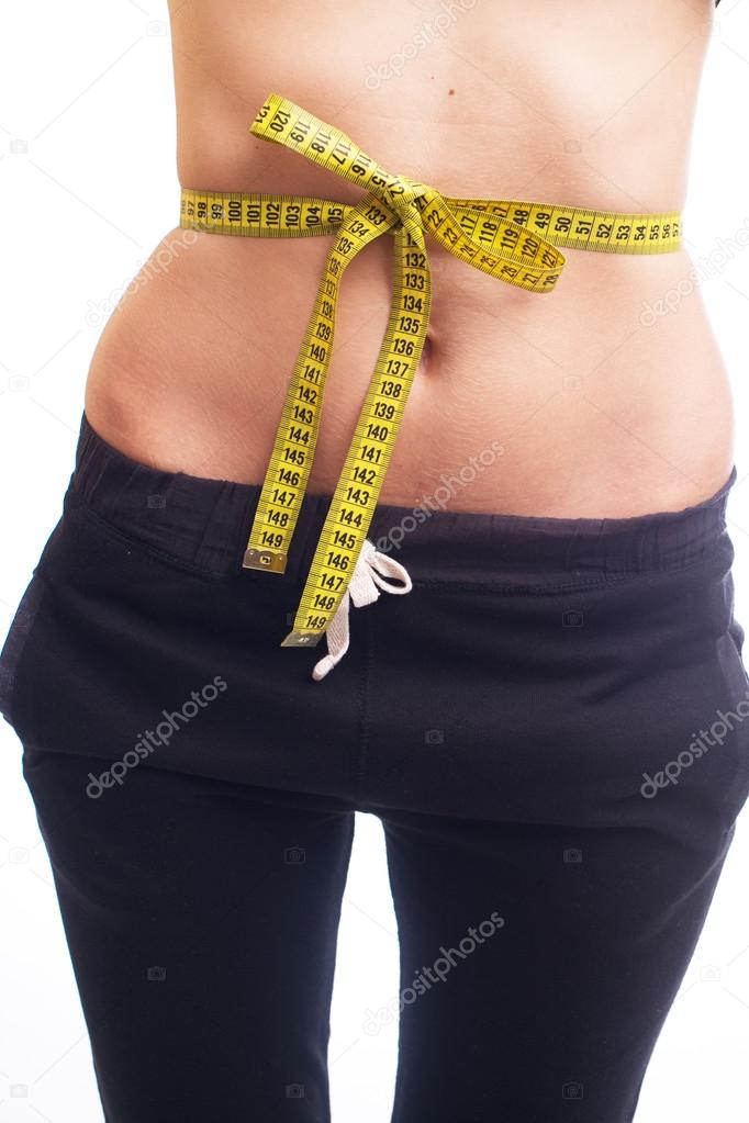 Slim woman measuring waist