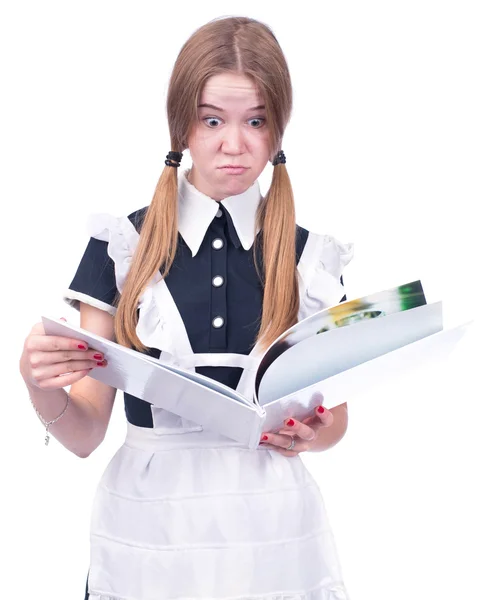 Surprised schoolgirl holding book — Stock Photo, Image