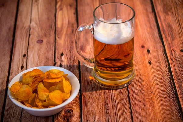 Mug of beer with potato chips — Stock Photo, Image