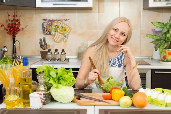 Kvinnan ler vid köksbordet — Stockfoto