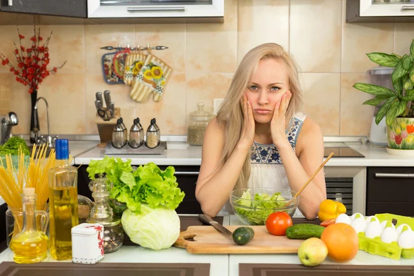 Woman with sad emotion at the kitchen table