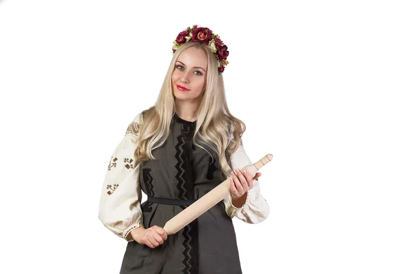 Beautiful woman in ukrainian costume with rolling pin — Stock Photo, Image