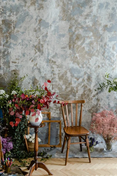 Old wooden chair in studio room with flowers