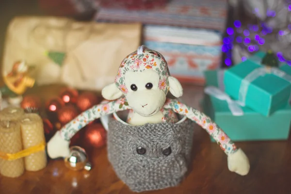 Christmas still life with toy monkey in knitted cup — Stock Photo, Image