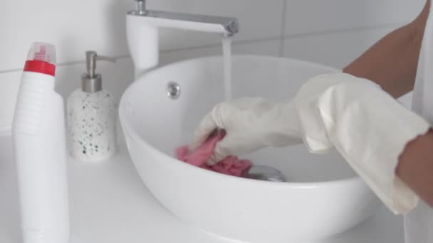 Gospodyni domowa w rękawiczkach myje zlew środkiem czyszczącym — Wideo stockowe