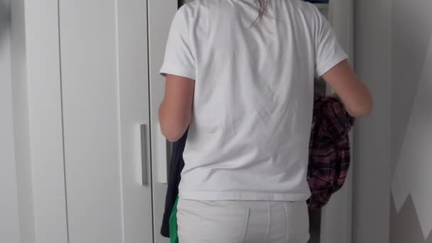 ママ主婦が服を着るのは男子生徒のクローゼットの中 — ストック動画