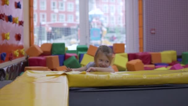 Una bambina salta su un trampolino in un centro di intrattenimento per bambini. — Video Stock