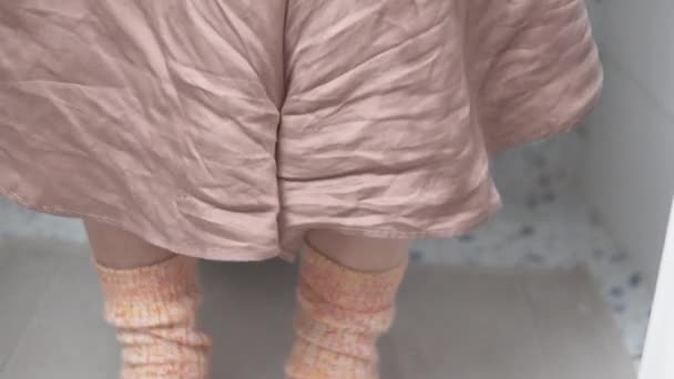 Vrouwen benen in wol sokken zitten op het toilet in het toilet — Stockvideo