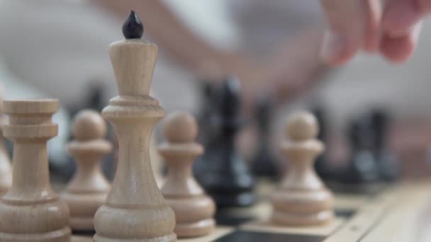 Κοντινό πλάνο, το αρσενικό χέρι αρχίζει το σκάκι με την κίνηση ενός λευκού πιονιού. — Αρχείο Βίντεο