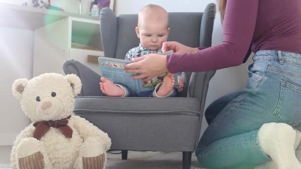 Máma ukazuje malému dítěti obrázkovou knížku — Stock video