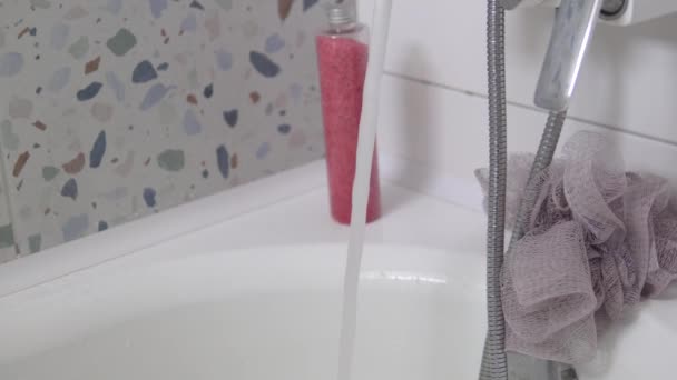 Μια γυναίκα ελέγχει τη θερμοκρασία του νερού στο μπάνιο., — Αρχείο Βίντεο