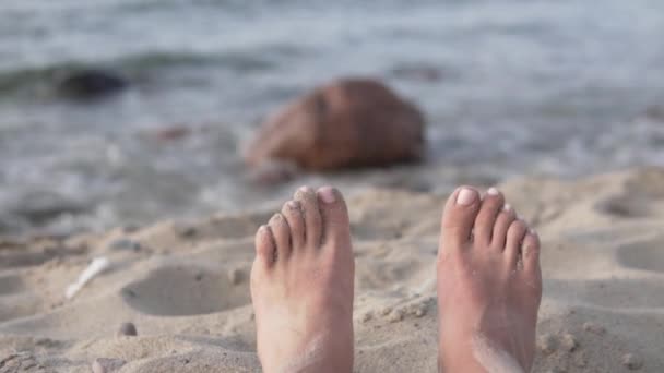 Close-up of womens legs against the background of the sea — Stock Video