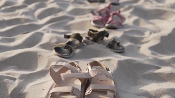 Närbild sandaler vuxna och barn på stranden — Stockvideo