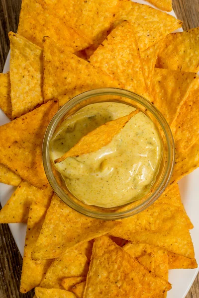 Nachos with cheese sauce — Stock Photo, Image
