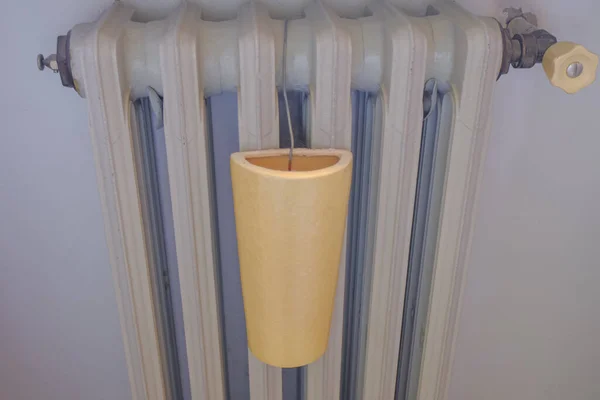 Grey radiator, faucet and ceramic humidifier close-up. Home radiator. Heating infrastructure