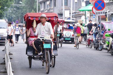 Bir hutong bir çekçek turistler, Antik hutongs Pekin şehrinin önemli bir kültürel unsuru temsil sokakları tarafından oluşturulur