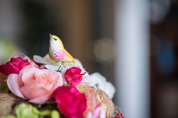 一个假鸟和彩色的玫瑰花 — 图库照片