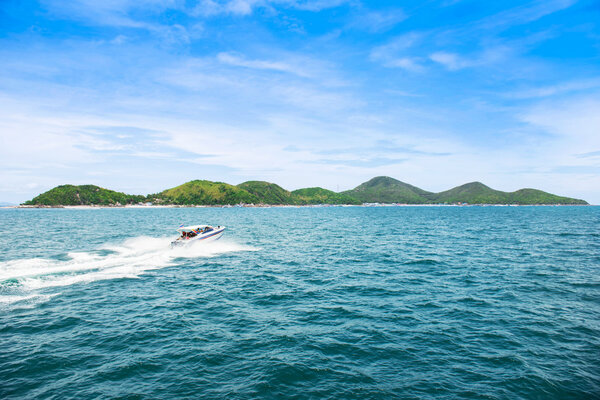 Tropical island and speed boat