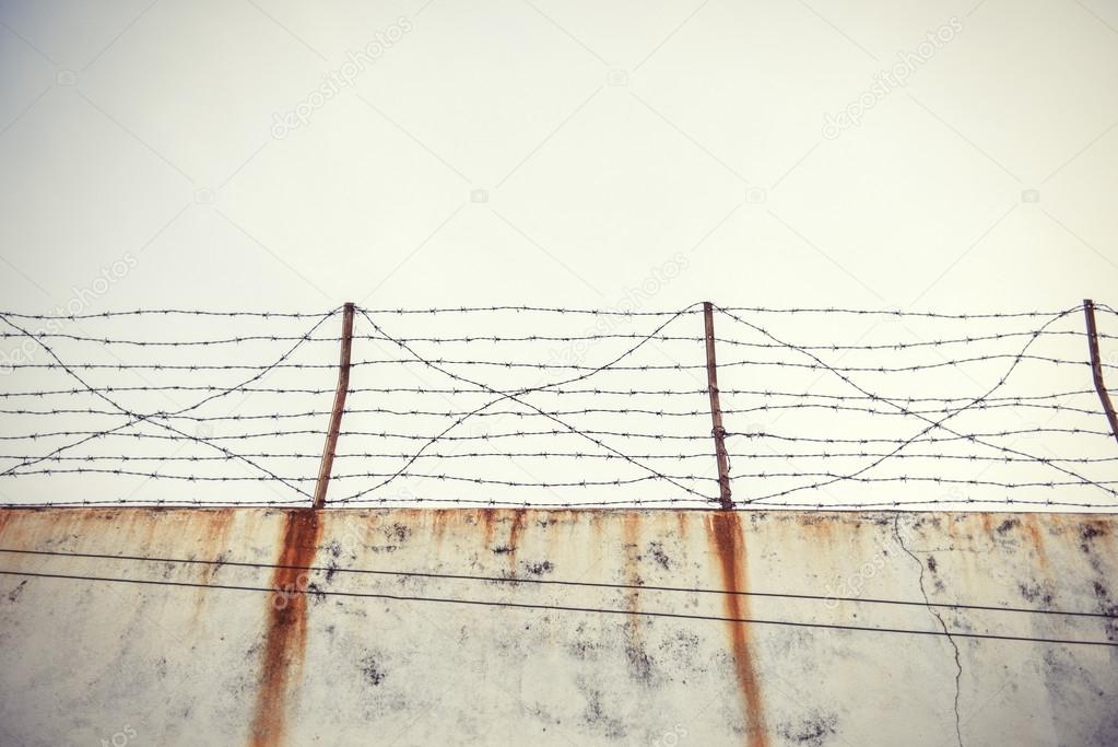 Barbed wire and old wall