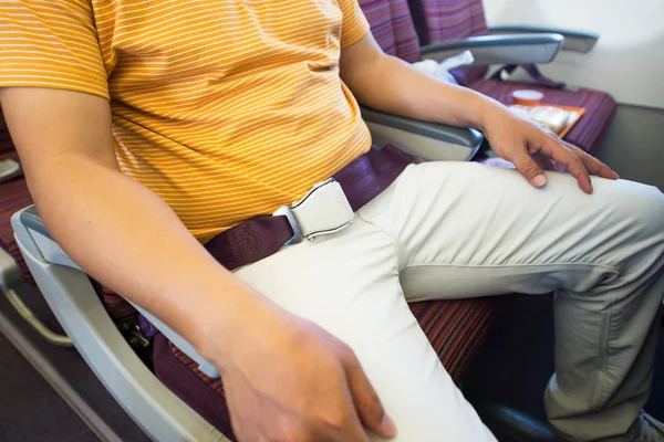 Man sitting wiht security belt on board — Stock Photo, Image